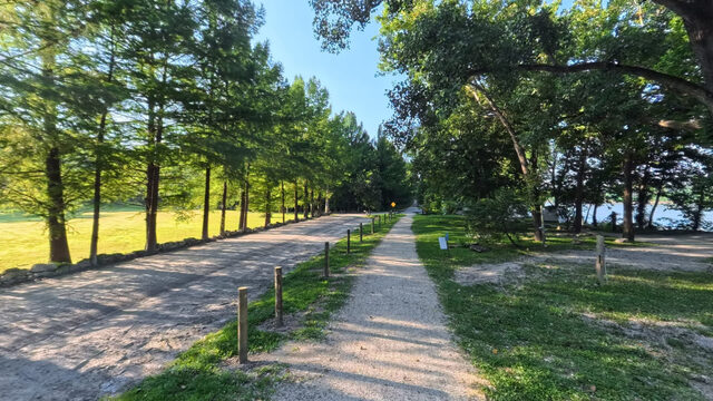 Tree-lined trail at Cooper's Landing with the Missouri River beyond